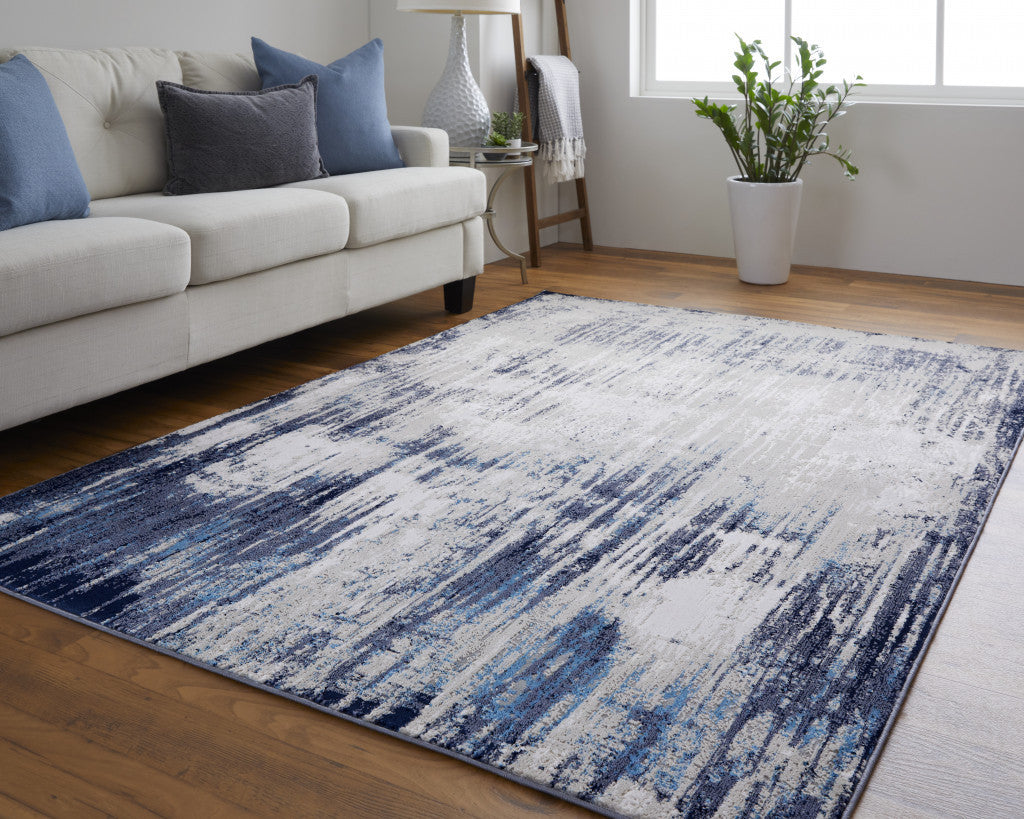 5' X 8' Tan Blue And Ivory Abstract Power Loom Distressed Area Rug