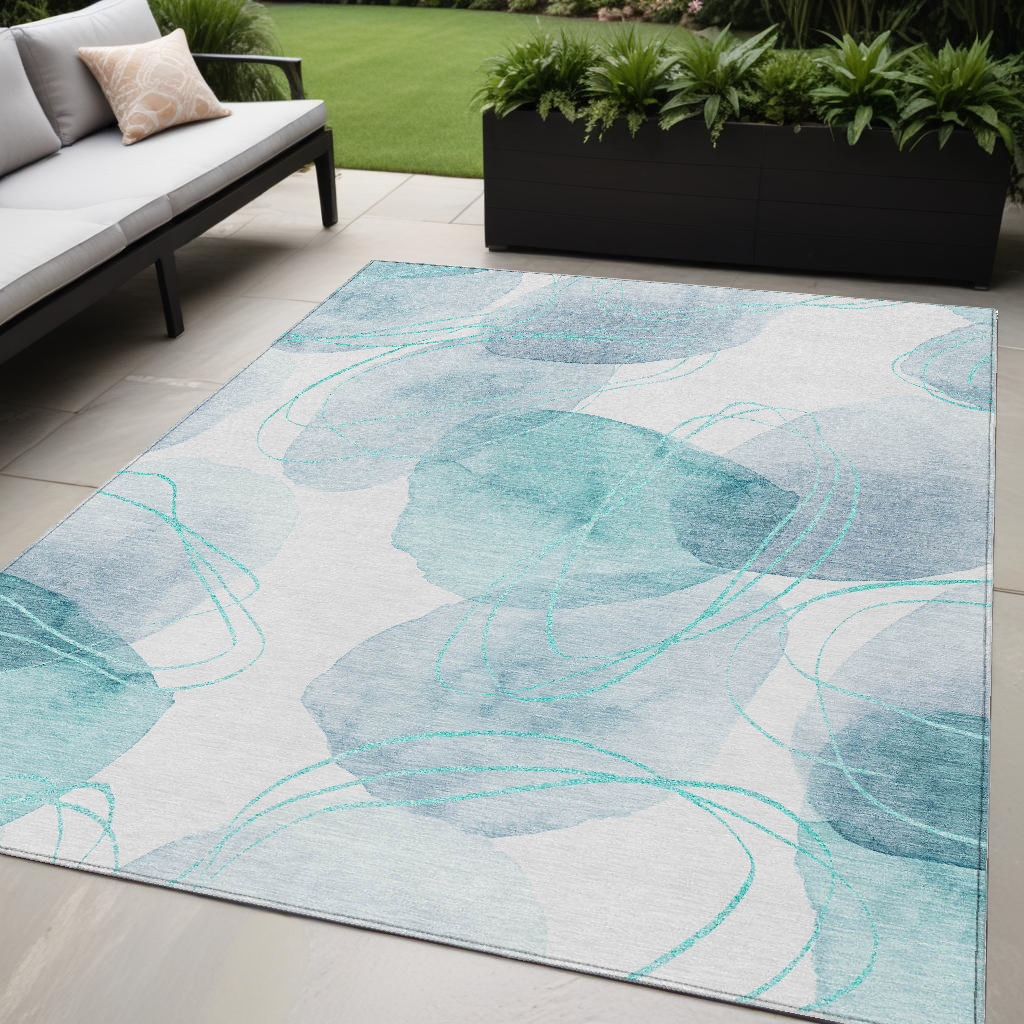 5' X 8' Teal and Ivory Abstract Washable Non Skid Indoor Outdoor Area Rug